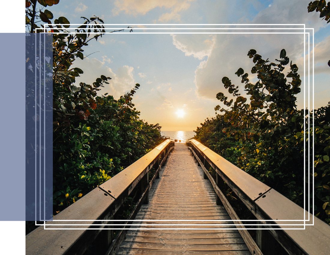 A boardwalk leading toward the sunset